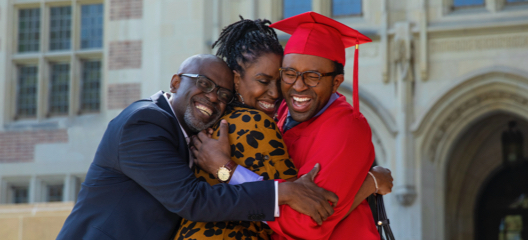 College graduate celebrating with his parents