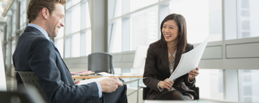 Husband and wife talk to their Merrill financial advisor 