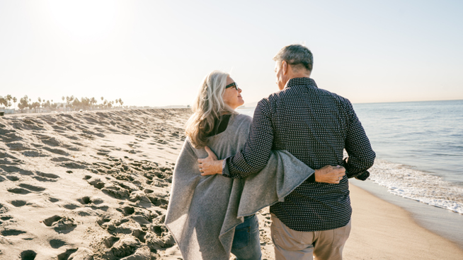 A couple takes a stroll on the beach